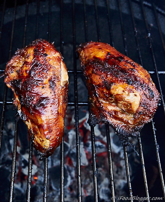 Chicken breasts on a grill.