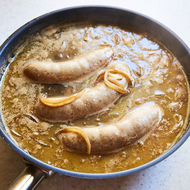 Here is the best way to cook brats to end with juicy, flavorful sausages that snap when you bite into them. Grilled over direct heat, with Mesquite smoke. You may also like Beer Brats using Alton Brown's recipe for that malty beer flavor.