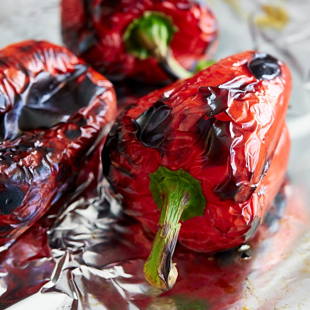 Roasted bell peppers on a baking sheet.