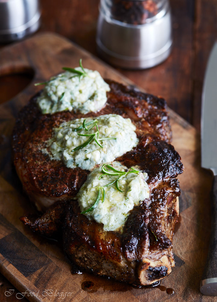 Pan-seared ribeye steak, finished in the oven for perfect doneness, then topped with blue cheese and shallot compound butter and fresh rosemary.