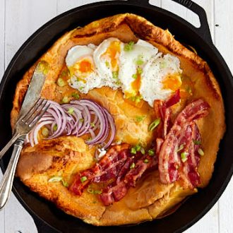 Savory Dutch Baby served with poached eggs, fried bacon and onions | ifoodblogger.com