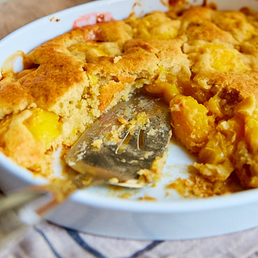 Ridiculously Easy Peach dump cake recipe! Also called peach crunch cake because of the crunchy crust. Delightful made with fresh peaches, and just as good made with canned peaches. Just dump peaches, cake mix and butter into a baking dish and bake. A cake recipe doesn't get any simpler than that.