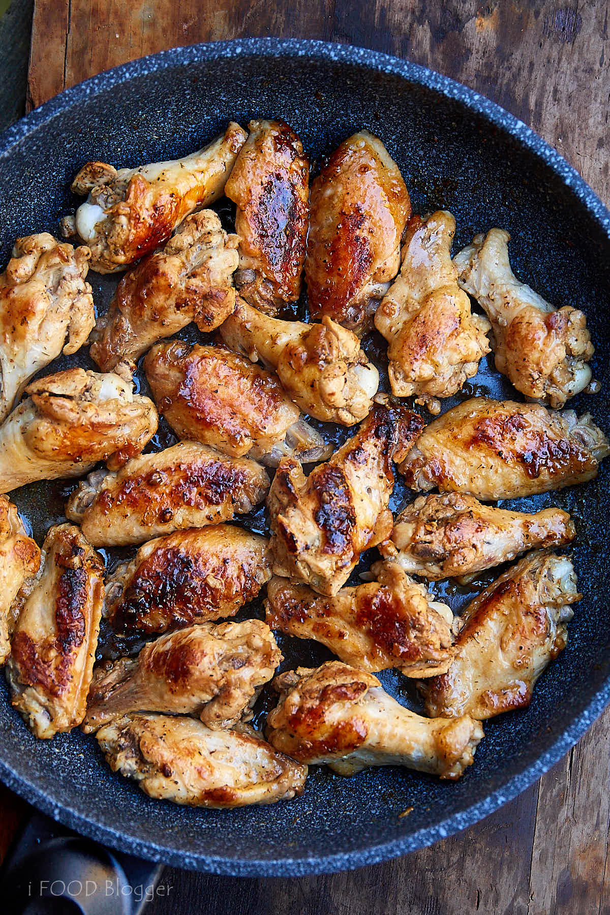 Learn how to fry chicken wings to make them super tender and flavorful. Try this recipe, you will love it. Chicken wings are first pan seared then cooked covered over low heat. All done in 30 minutes. | ifoodblogger.com