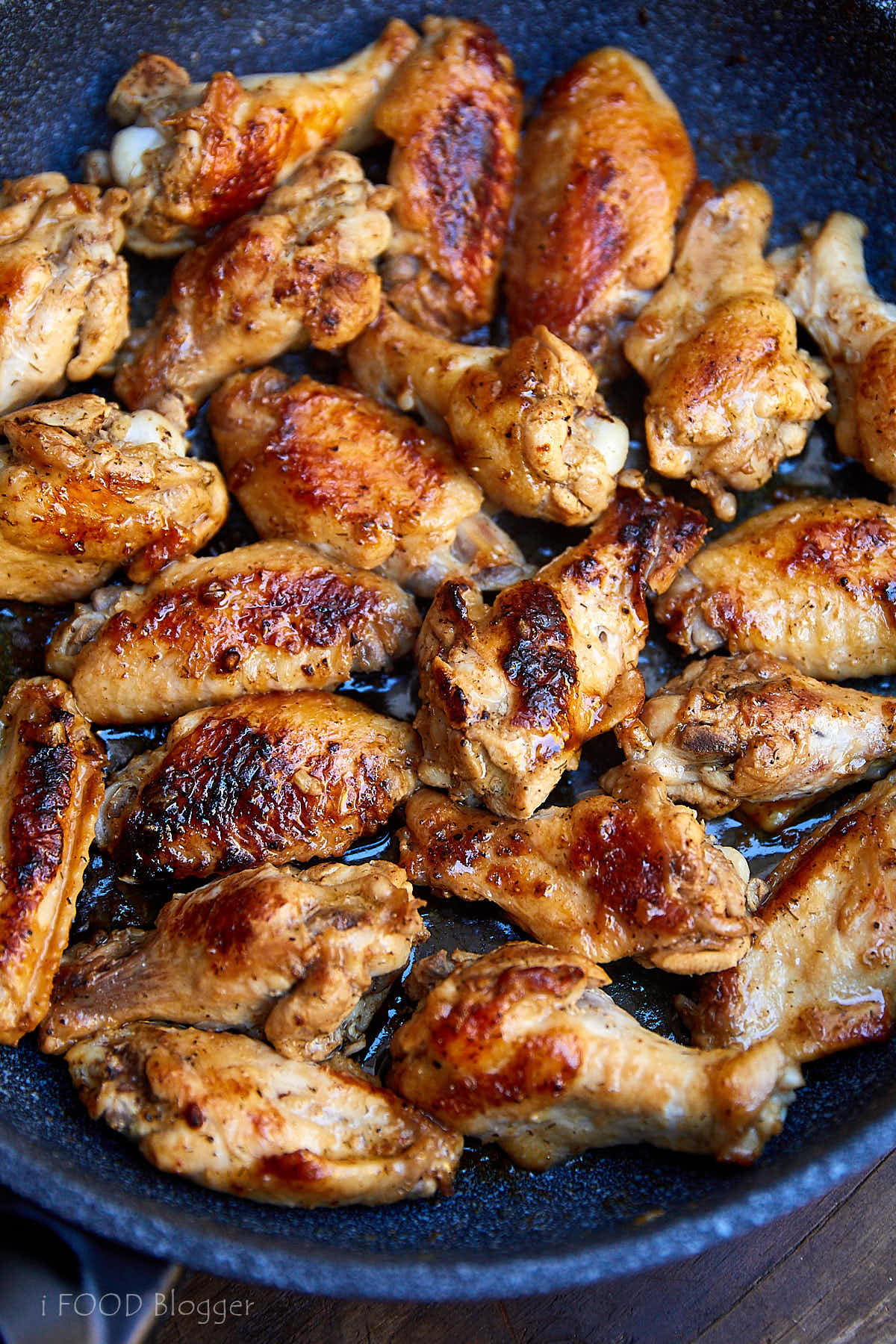 Learn how to fry chicken wings to make them super tender and flavorful. Try this recipe, you will love it. Chicken wings are first pan seared then cooked covered over low heat. All done in 30 minutes. | ifoodblogger.com