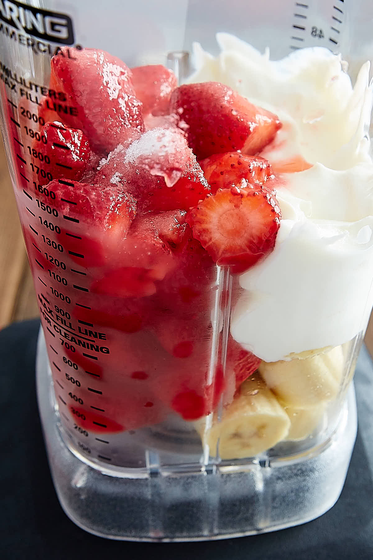 Banana, strawberry and chocolate milkshake in plastic cup with