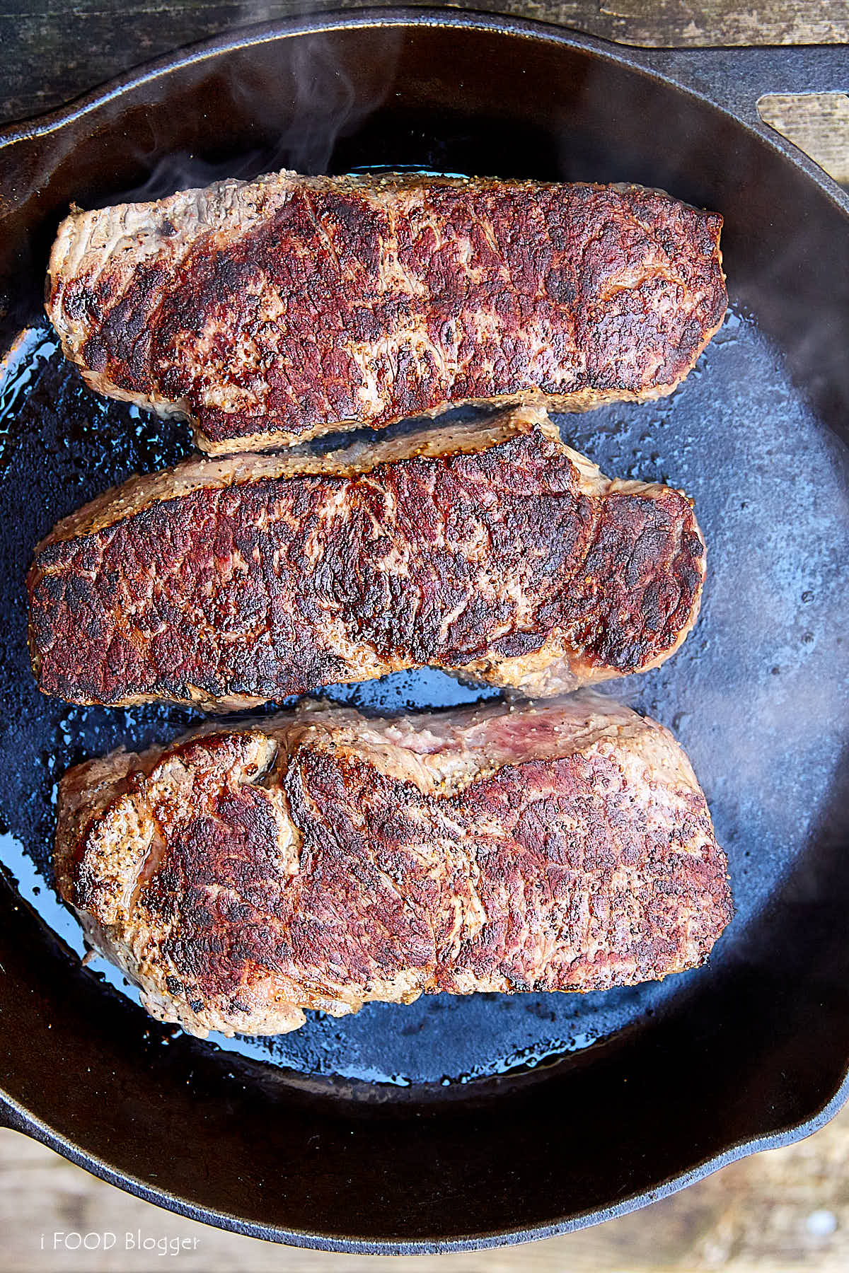 Learn how to make a perfect steak on the stove with this easy to follow guide.The best way to cook a steak indoors is to start with pan searing and finish in the oven. The steak will be perfectly caramelized on the outside and tender inside. Then let it rest and finish quickly in the oven. This will give the a perfectly cooked, tender and juicy steak every time. The best steak ever. | ifoodblogger.com