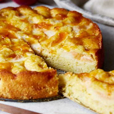 This recipe for a super moist German apple cake is a must try. The addition of almond paste and peach jam make it moister and more flavorful. A little extra effort is required to make it, but it's very well worth it.