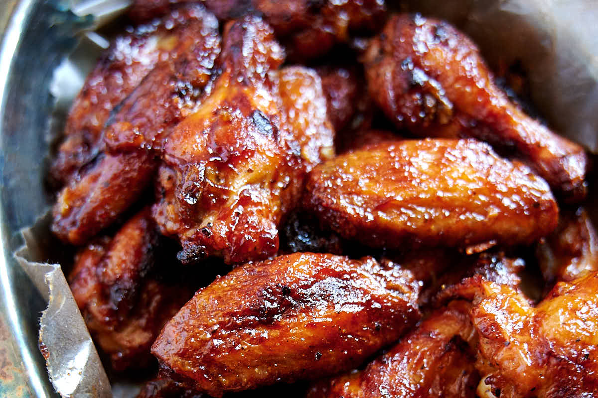 Best Baked BBQ Chicken Wings, period. First, the wings are baked on convection until super crispy, then coated in BBQ sauce and baked some more. The end result is sticky and addictive baked chicken wings that you can't have enough of. | ifoodblogger.com