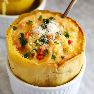 Kid friendly Spaghetti Squash bowls filled with vegetables mixed in a creamy, cheesy goodness. It's like a mac and cheese, only much healthier.