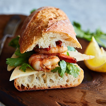 Shrimp sandwich made with grilled shrimp, freshly baked baguette, delicious shrimp dipping sauce, cilantro and spicy habanero jack cheese. 