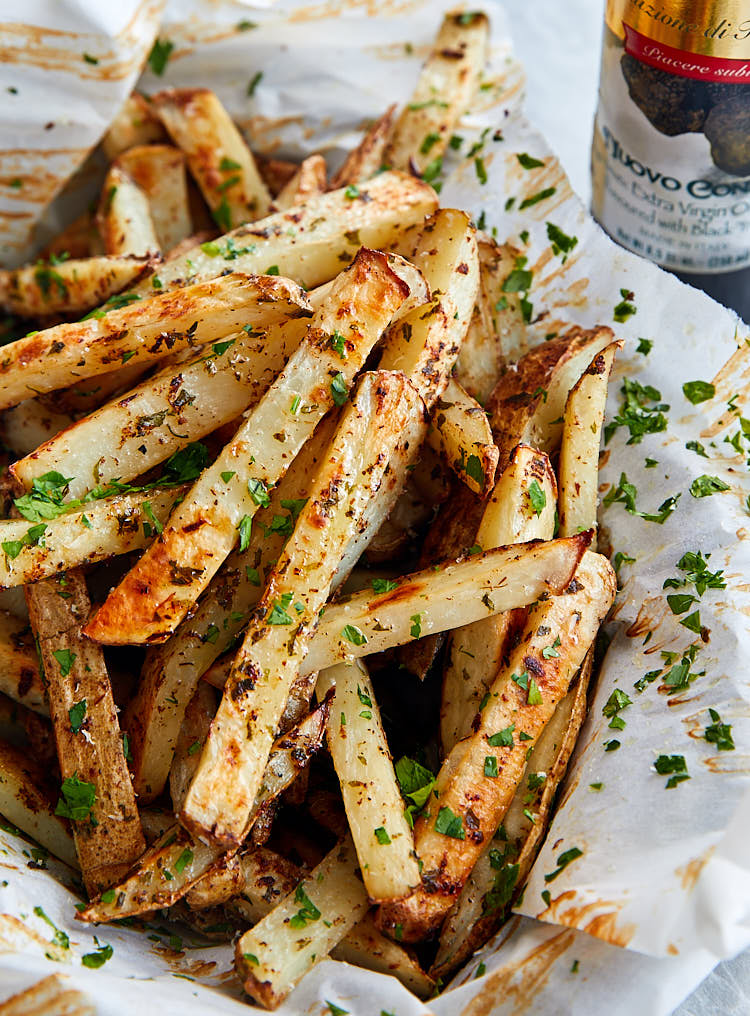 A pile of truffle fries in a basket.
