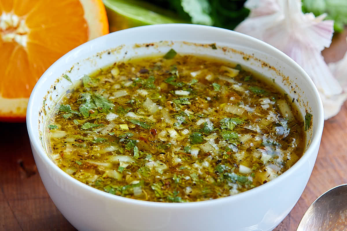 A close up of a white bowl with mojo sauce in it.